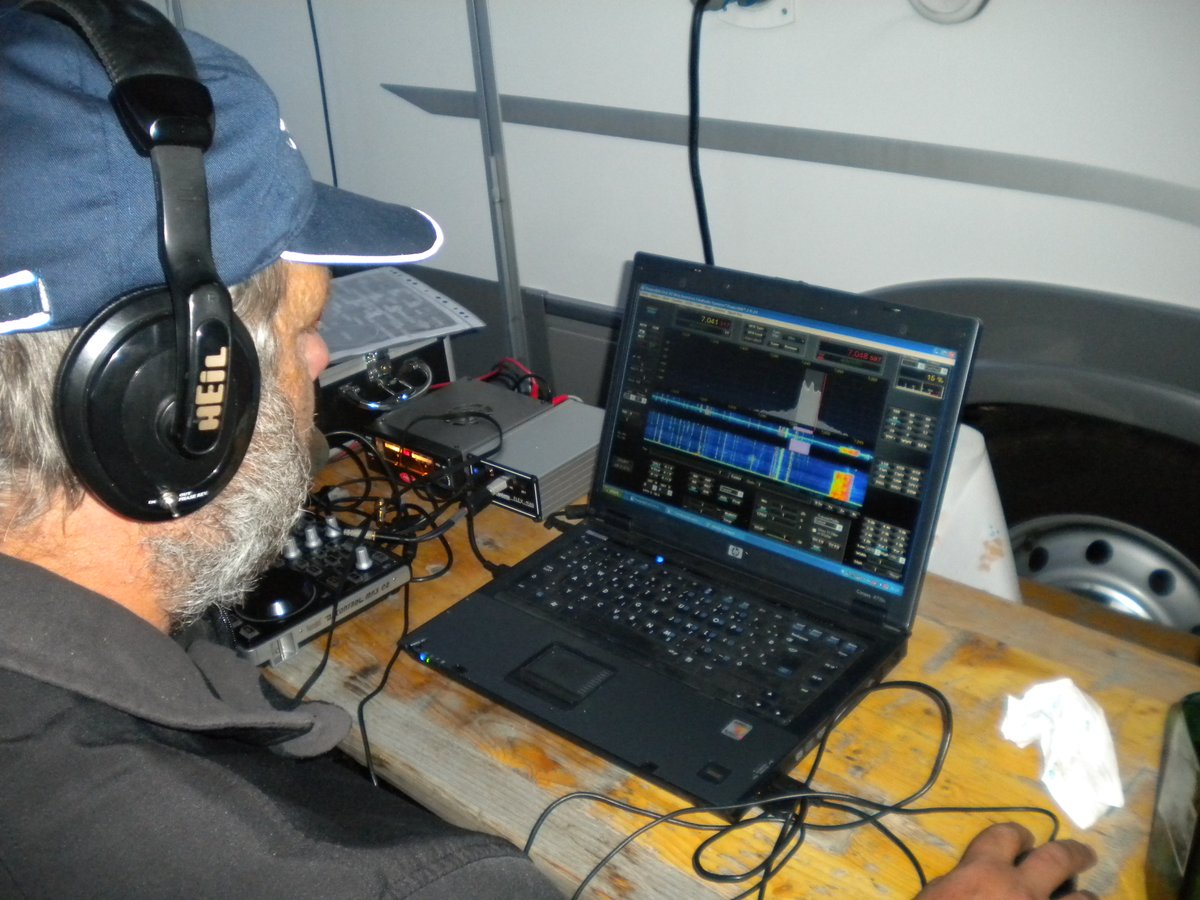 A laptop showing a waterfall display with a small USB receiver beside it