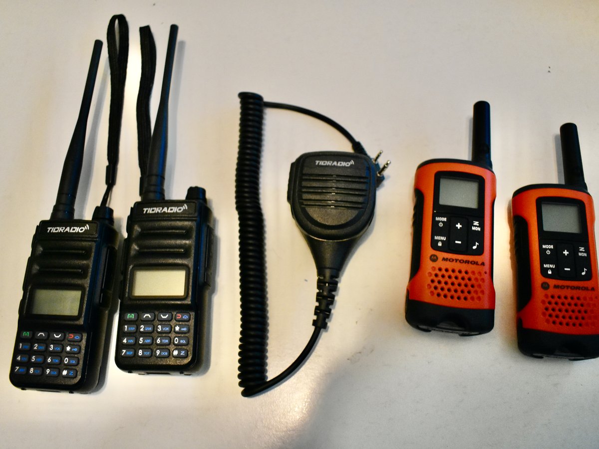 Six different radios in a row on a workbench