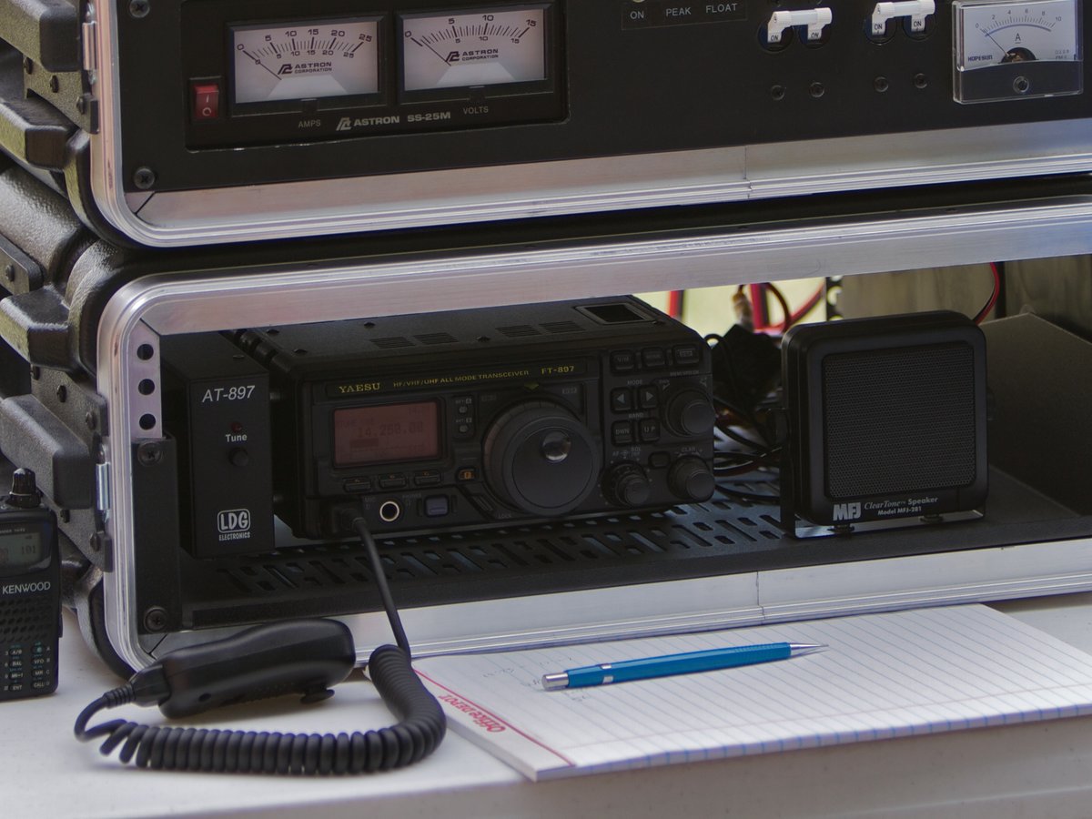 Several kinds of handheld radio laid out on a table