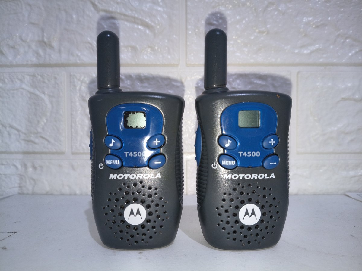 Two GMRS handheld radios on a truck tailgate